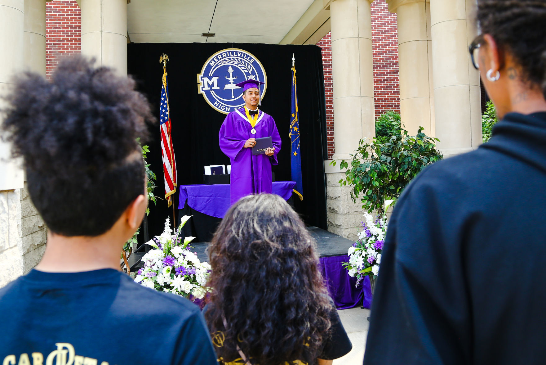 Merrillville High School seniors participate in a "drive-up" graduation